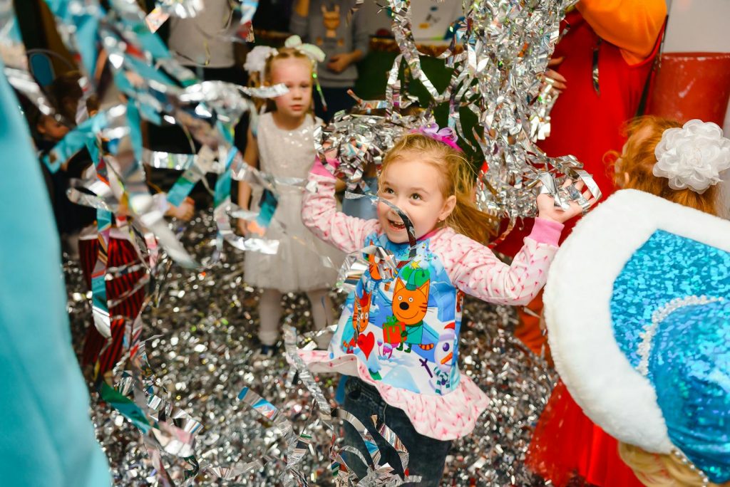 Premier Writer Cruz Tells Teachers to Make Catch-up Fridays Simple While Achieving Purpose 6 Joyful children having fun at an indoor party, with colorful streamers adding to the festive atmosphere.