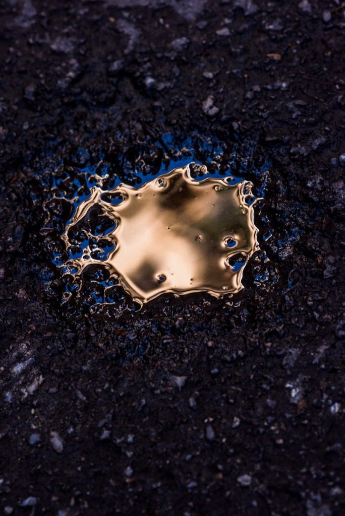 Proudly: Filipino High School Students Developed an Automated Oil Spill Cleaner 7 Artistic reflection of golden oil on asphalt creates a unique abstract image.
