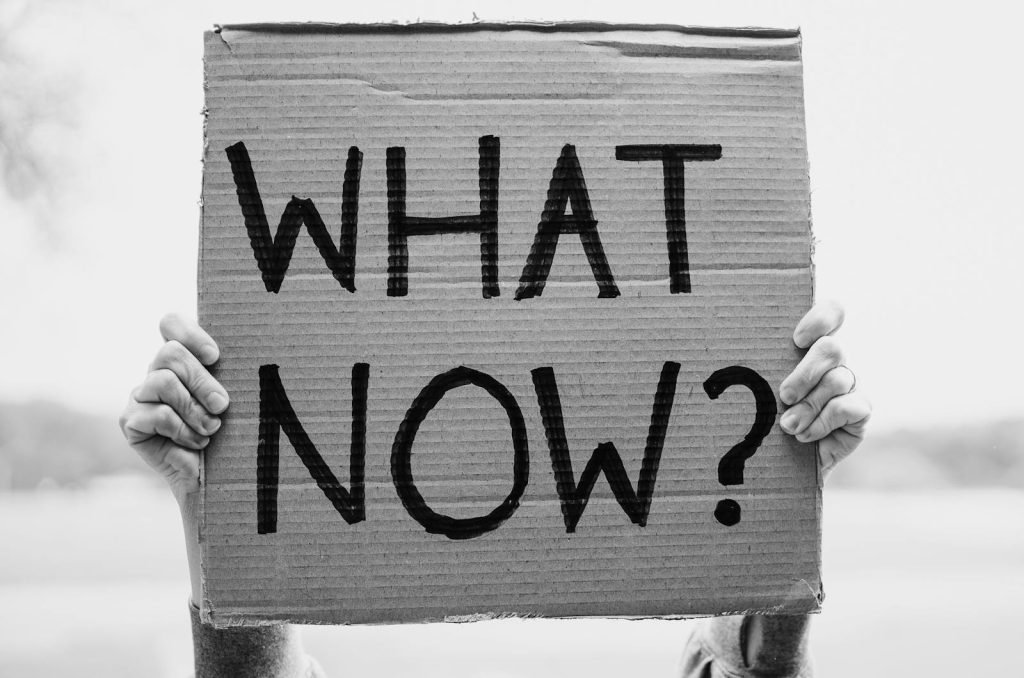 5 Supreme Techniques for Effective Questioning and How to Apply it in Class Like a Pro 6 A close-up of hands holding a cardboard sign with the text 'What Now?'