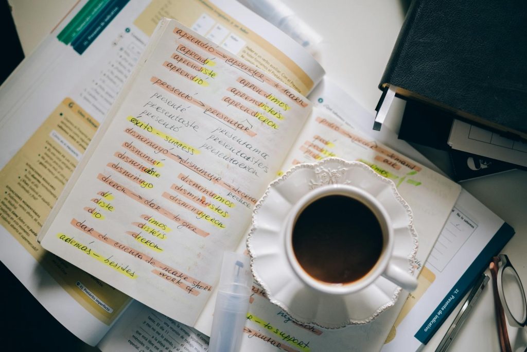 9 Indubitable Tactics to Pass College Entrance Exam Like a Maven 6 A cup of coffee on handwritten Spanish notes for language learning inspiration.