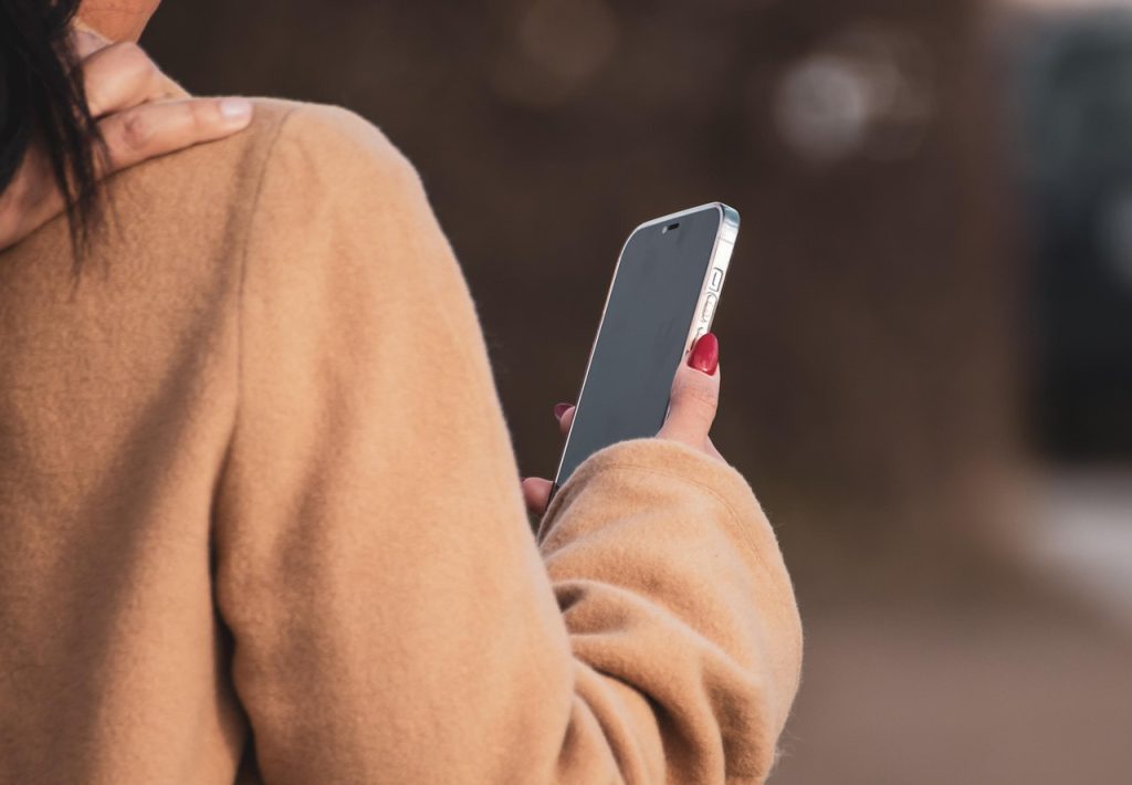 woman, hand, smartphone, mobile, cellphone, sweatshirt, rear view, close up, coat, cellphone, cellphone, sweatshirt, sweatshirt, sweatshirt, sweatshirt, sweatshirt, coat