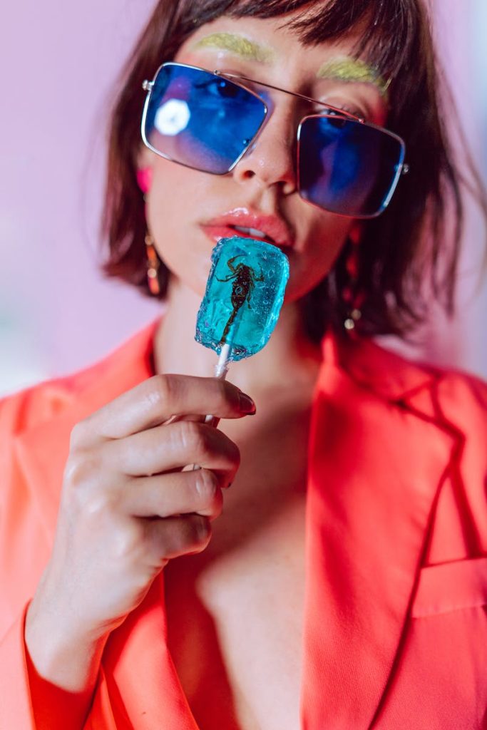 7-Point Checklist to Create Feature Articles that Goes Viral on Social Media in 7 Minutes 7 Stylish portrait of a woman in sunglasses holding a blue lollipop with a colorful fashion vibe.