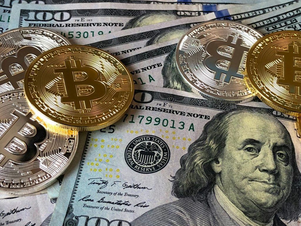 How to Find the Perfect Niche for Your Online Platforms or Social Media Pages in 7 Seconds 8 A close-up photo depicting Bitcoin coins on top of US dollar bills, symbolizing finance and cryptocurrency.