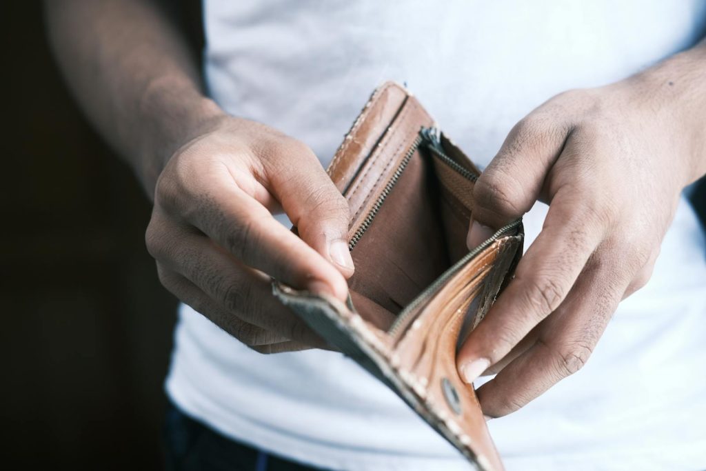 Worried She Shaded the Wrong Answer, Grateful She Topped the Nurse Licensure Exam 6 Close-up of hands holding an empty wallet, highlighting financial struggles and economic crisis.