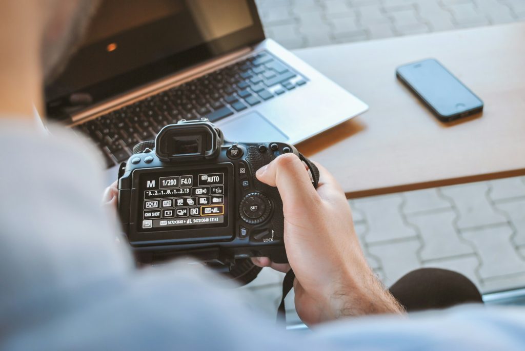 How to Create an Effective and Striking Photo Essay in Photojournalism 7 person holding black DSLR camera