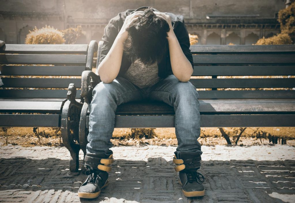 Both Parents Pass Away When He's 15, Lawyer Jules Millanar Shares He Once Felt Life is Pointless But He Never Gave Up 5 Man sitting alone on a bench in Agra, displaying signs of stress and loneliness.