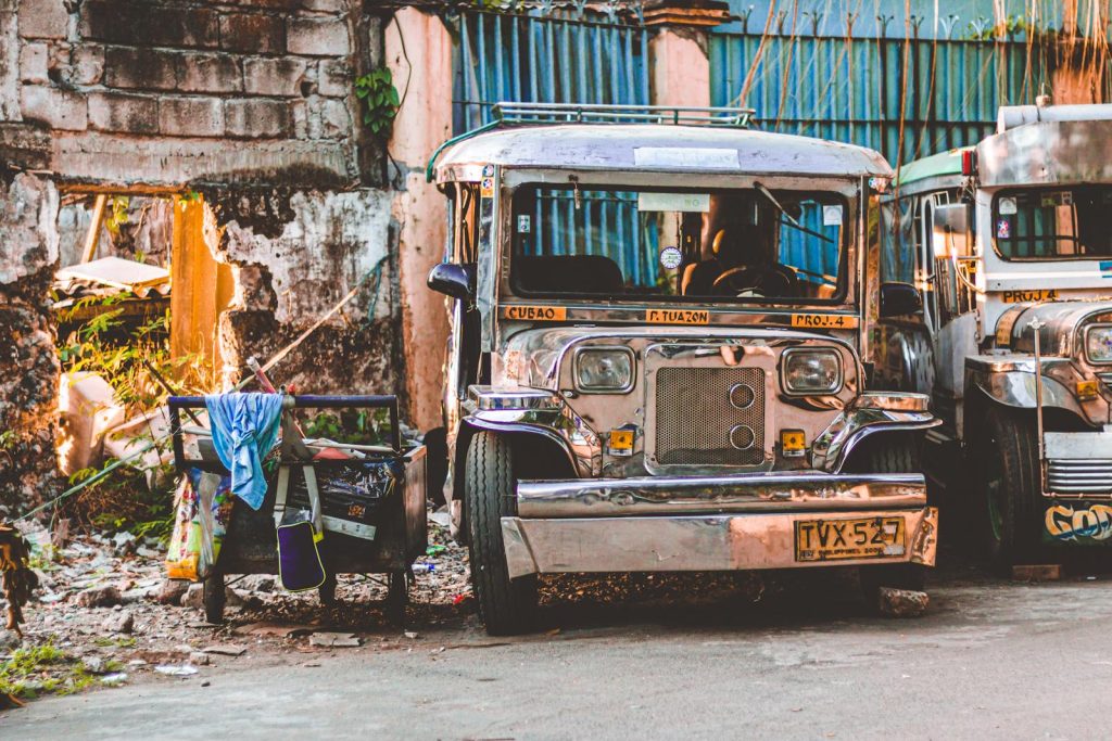 Jeepney Driver Refuses Fare, Recalls "Dahil sa inyo nagkabigas at nagkaulam kami noon" 5 Vintage jeepney parked in a vibrant Manila street, showcasing Filipino culture.