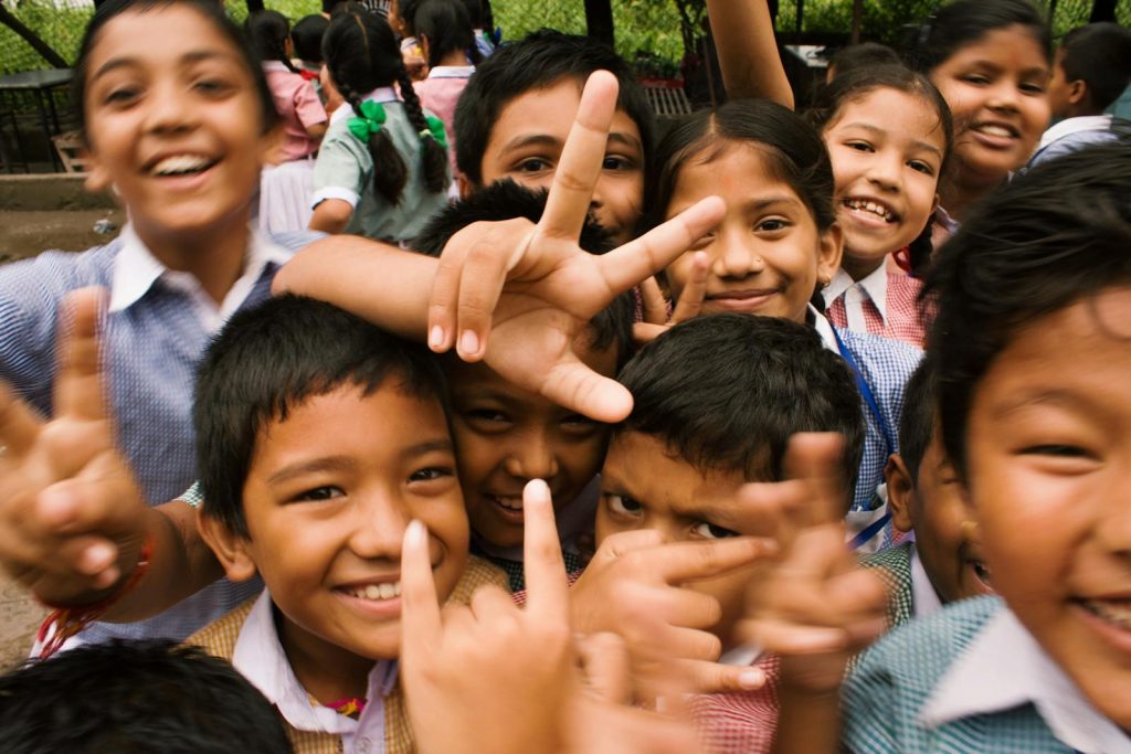 How to Create a Safe Philippines for Children? Series of Activities for Child Safety This 32nd Children's Month Launched 6 A joyful group of children smiling and making playful gestures outdoors in Namarjung, Nepal.
