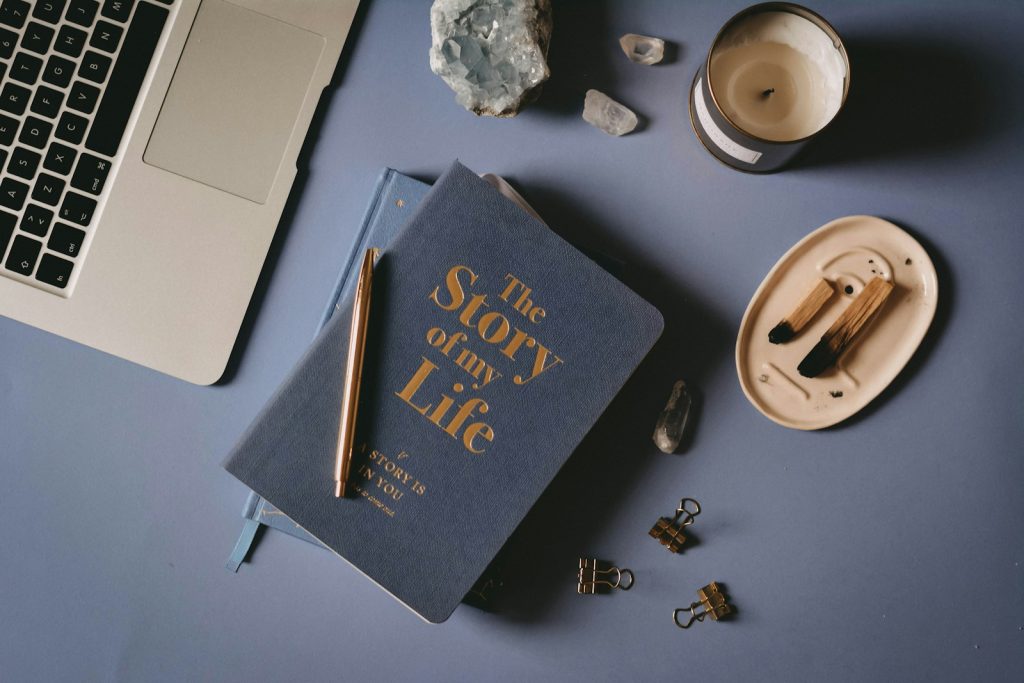 5 Truly Valuable Reasons to Use a Reflection Journal - Retain Better, Understand More, Self-Awareness 5 a book sitting on top of a table next to a laptop