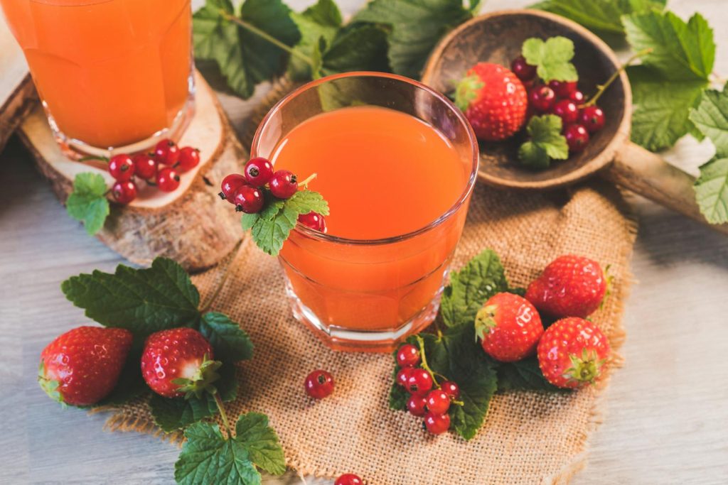 20-Year-Old Student Builds Flourishing Fruit Juice Business - From P50k Capital to Selling Up to 600 Cups Daily 5 A refreshing glass of berry juice surrounded by fresh strawberries and red currants. Perfect for a healthy lifestyle.