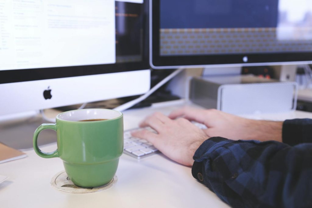 7 Tips on How to Use Dual Coding - The Powerful Combo of Words and Visuals to Double Your Learning Efficiency 10 Person typing at a desk with coffee and computer screens. Perfect for business or technology themes.