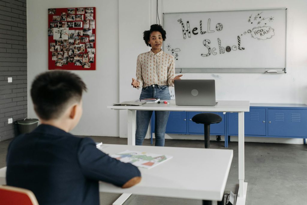 Interleaved Practice Makes You Learn Several Skills at Once 10 Educator leads interactive lesson in a classroom with a whiteboard display.